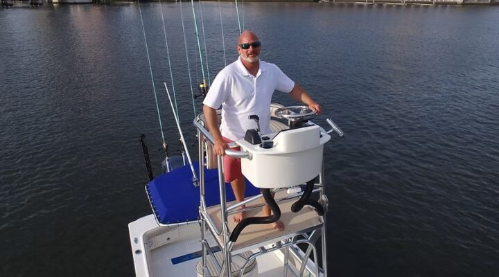 Tampa Inshore Fishing captain at the boat tower helm