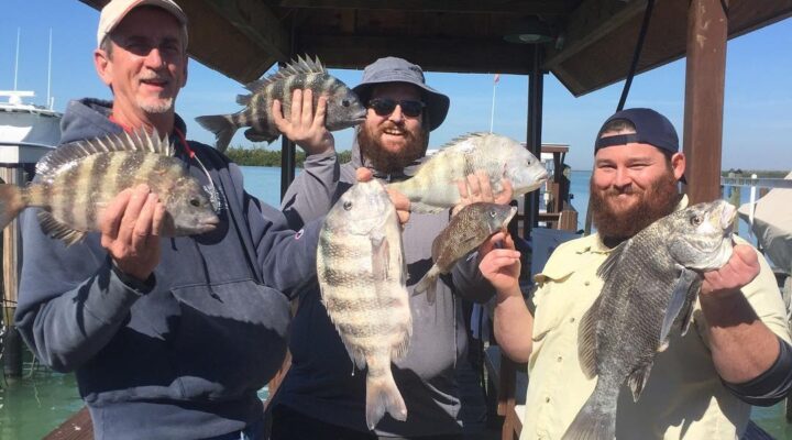 Three anglers displaying their catch at the marina with Florida's Finest Fishing