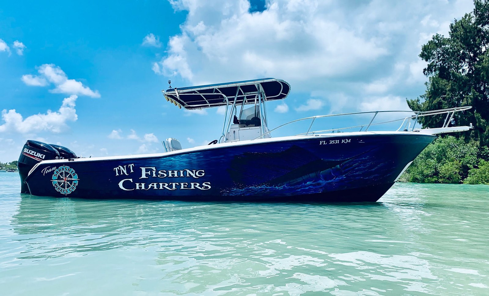TNT Fishing Charters blue center console boat near shore
