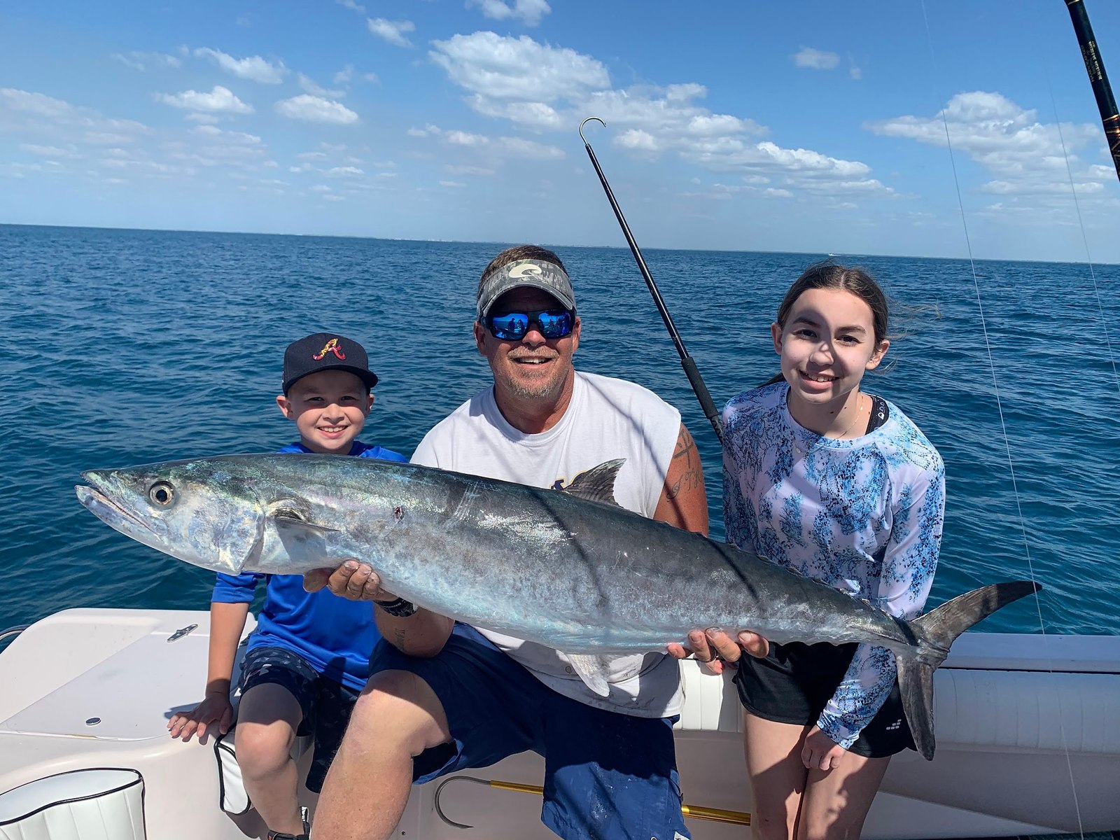 TNT Fishing Charters family holding a large amberjack