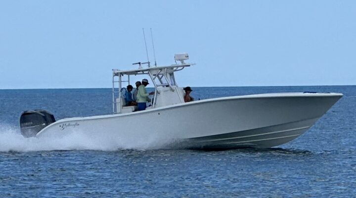 Top Priority white center console fishing boat underway