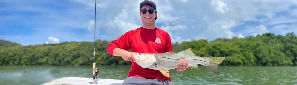 Treasure Island Fishing Charters angler holding a snook