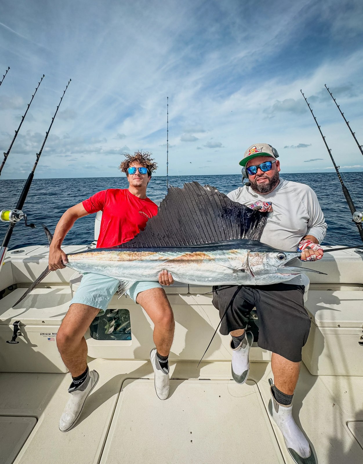 Two anglers displaying a wahoo aboard All Keys Charters
