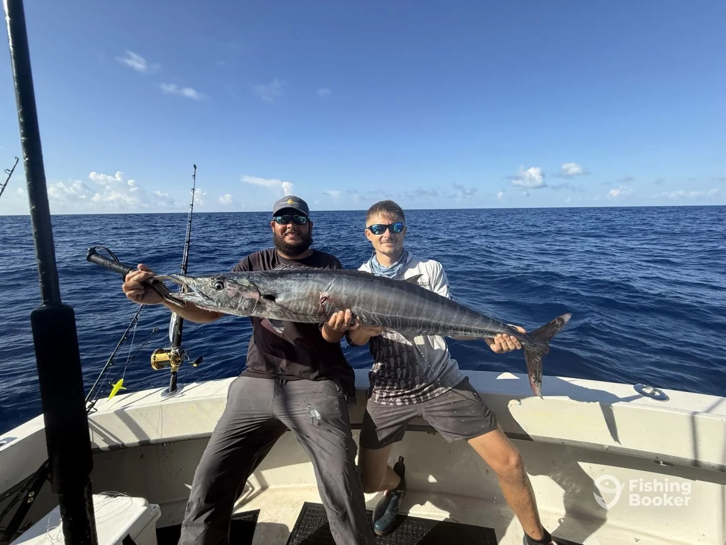 Two anglers holding a sailfish aboard Atlantic and Gulf Fishing Charters