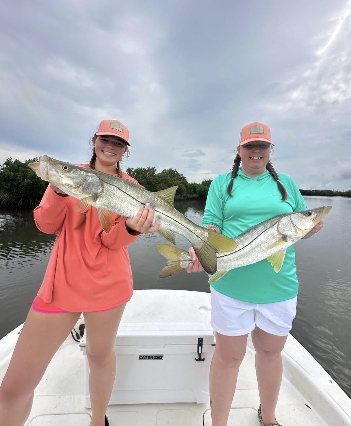 Two Big 3 Charters anglers holding their fish aboard the boat