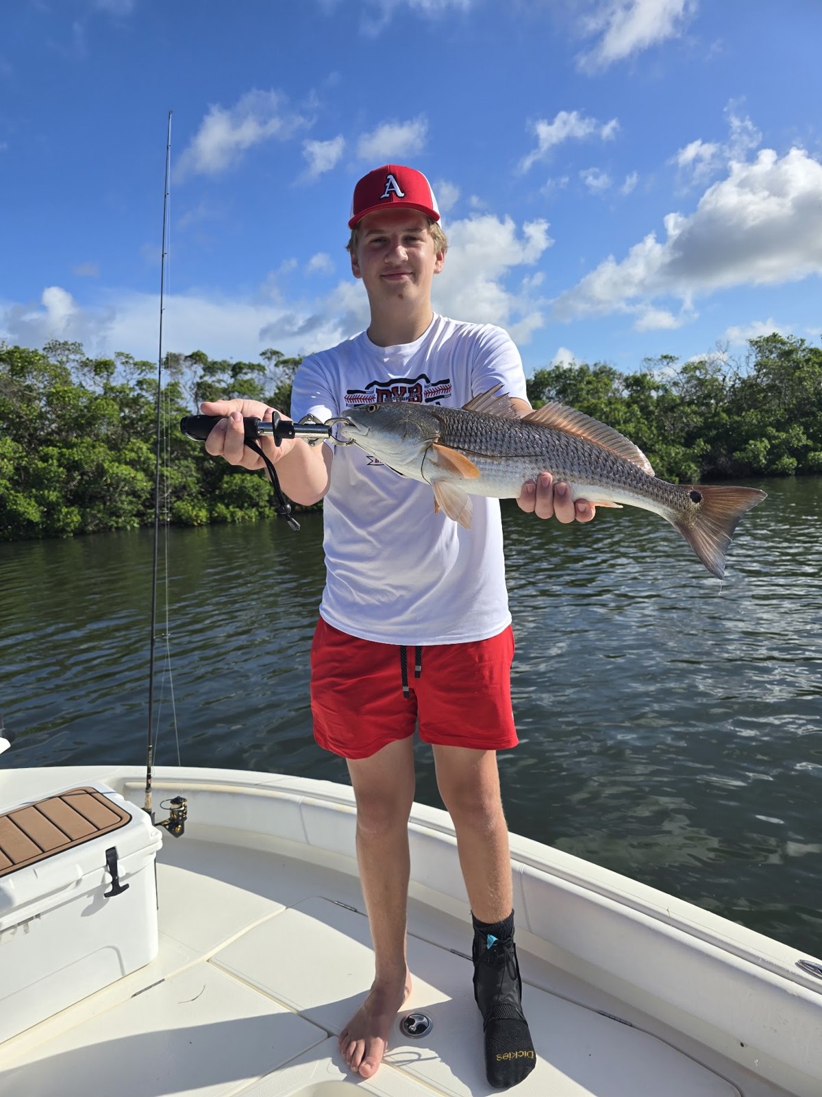 Whipp It Reel Good Charters young angler holding a redfish