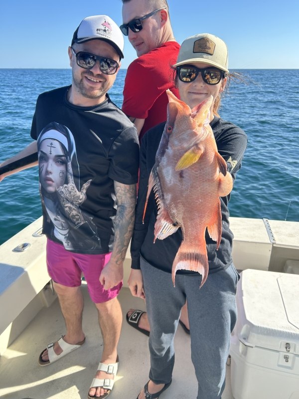 Young Double Hook anglers holding fish on an offshore trip