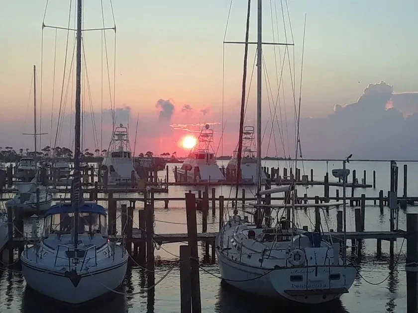 A fishing boat at a marina at sunset on the Reel Bandit website