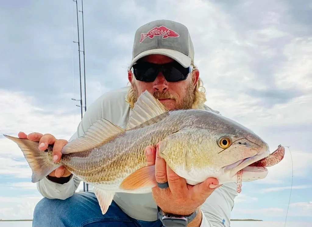 A redfish held close to the camera on an Angry Fish charter