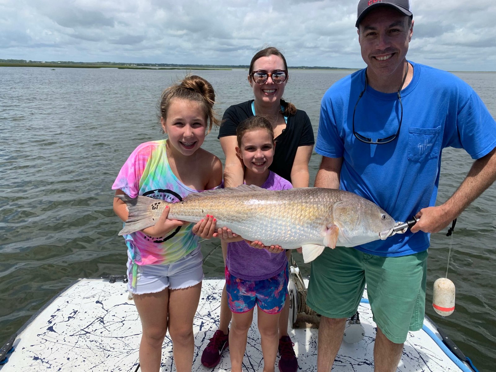 Amelia Island Charters family displaying a redfish