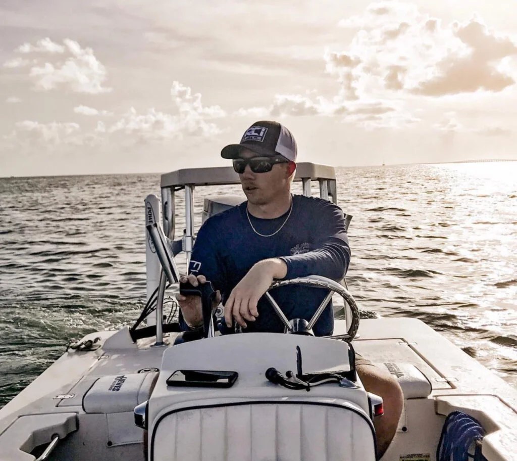 Amplifly Charters captain seated beside the skiff console