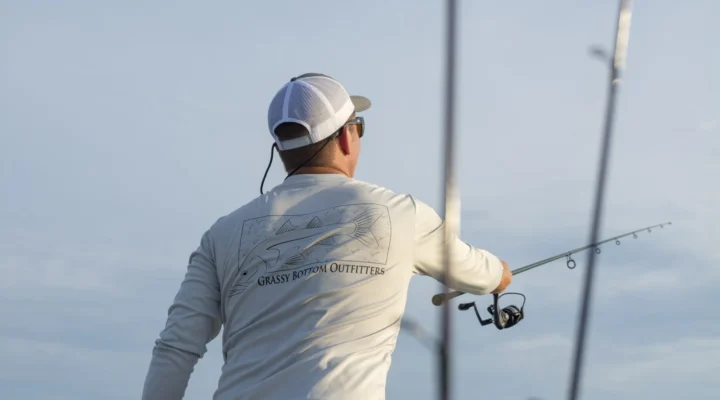 An angler casts a spinning rod from a Ranger Angler inshore trip