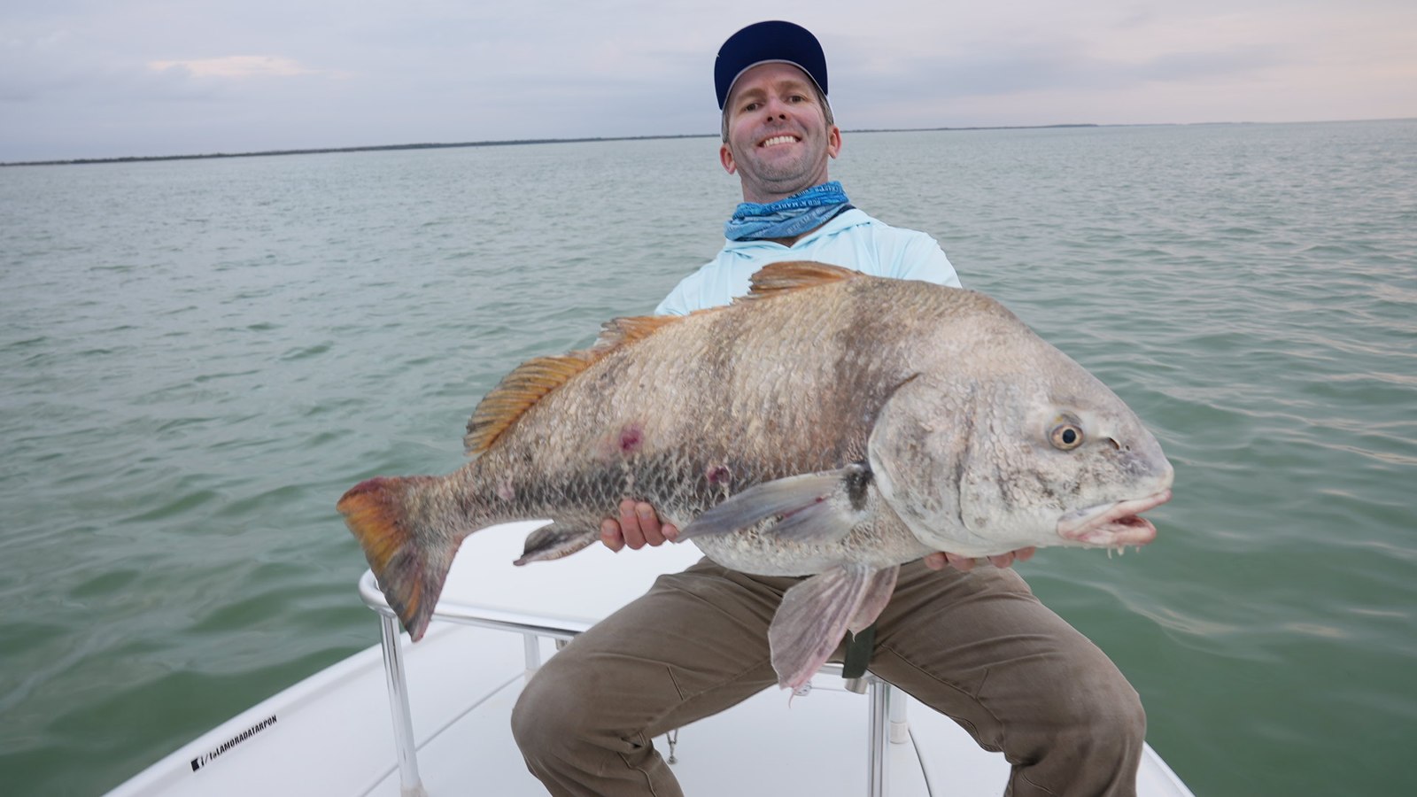 Angler displaying a black drum on Captain Rick Stanczyk's fishing trip