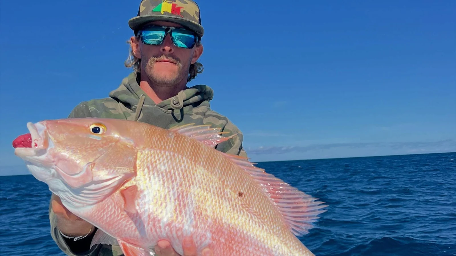 Angler displaying a mutton snapper on a Next Chapter Charters trip