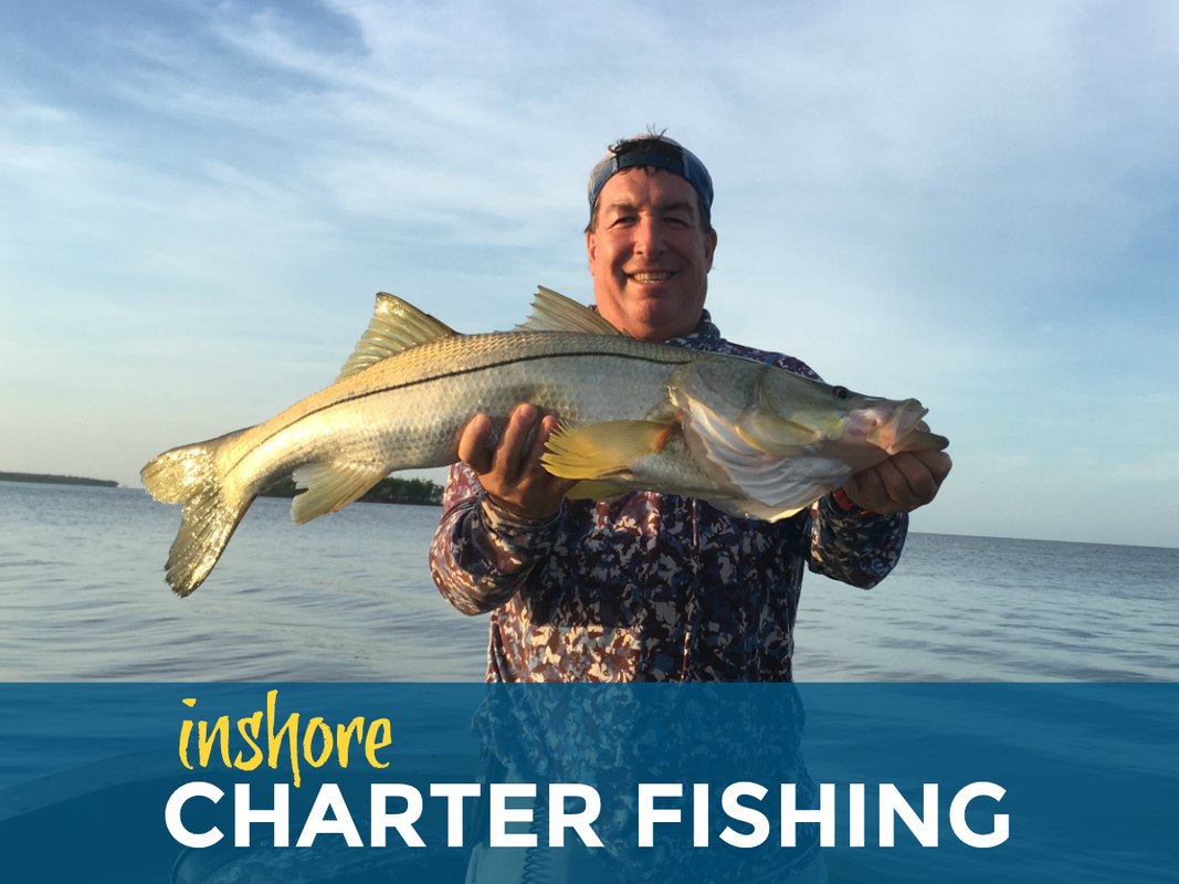 Angler displaying a snook with Naples Fishing Adventures