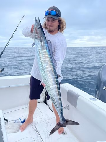 Angler displaying a wahoo with TenX Charters