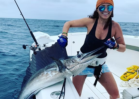 Angler holding a barracuda with Reel Intense Fishing Charters