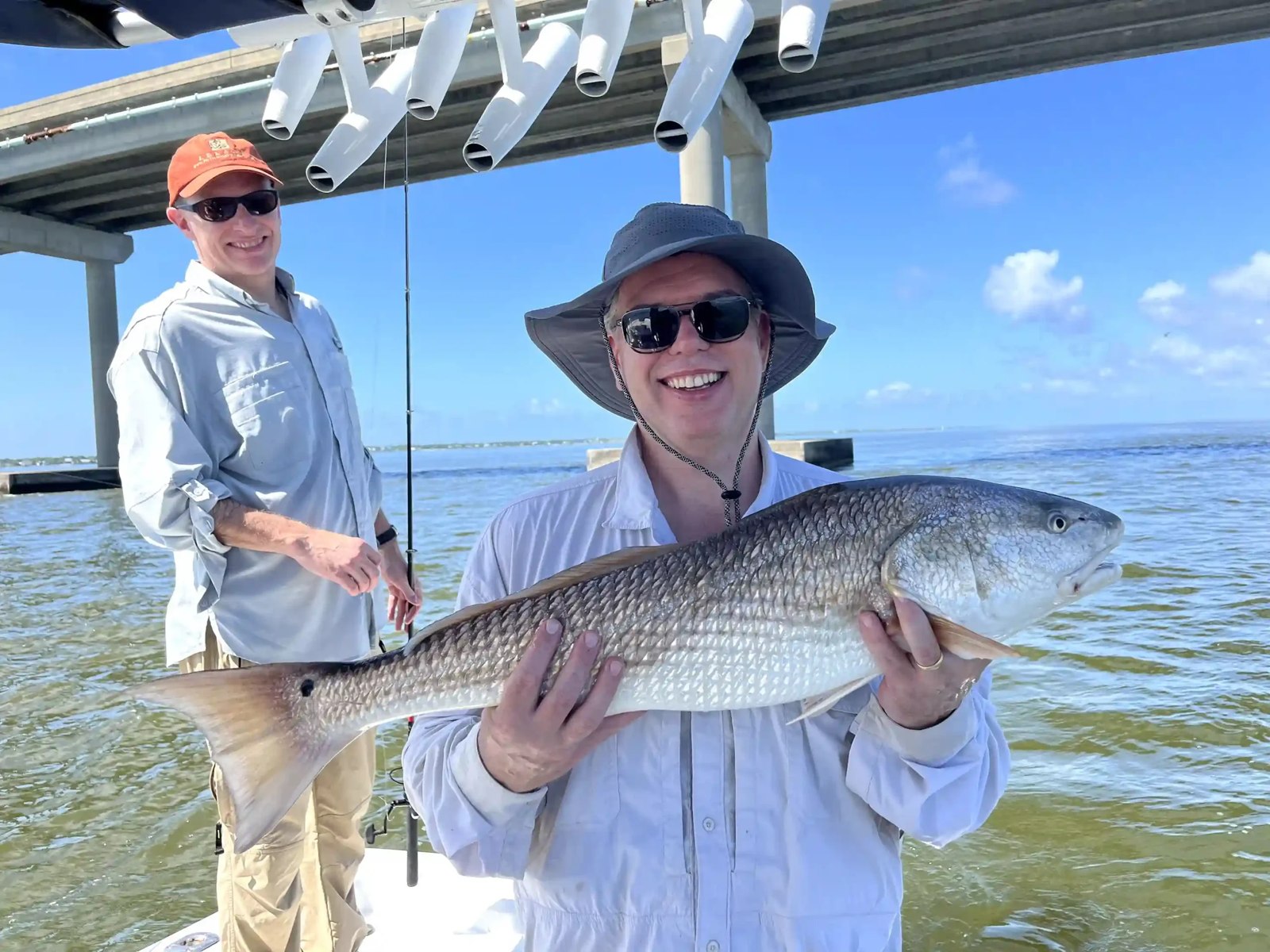 Angler holding a redfish aboard Apalachicola Guide Service