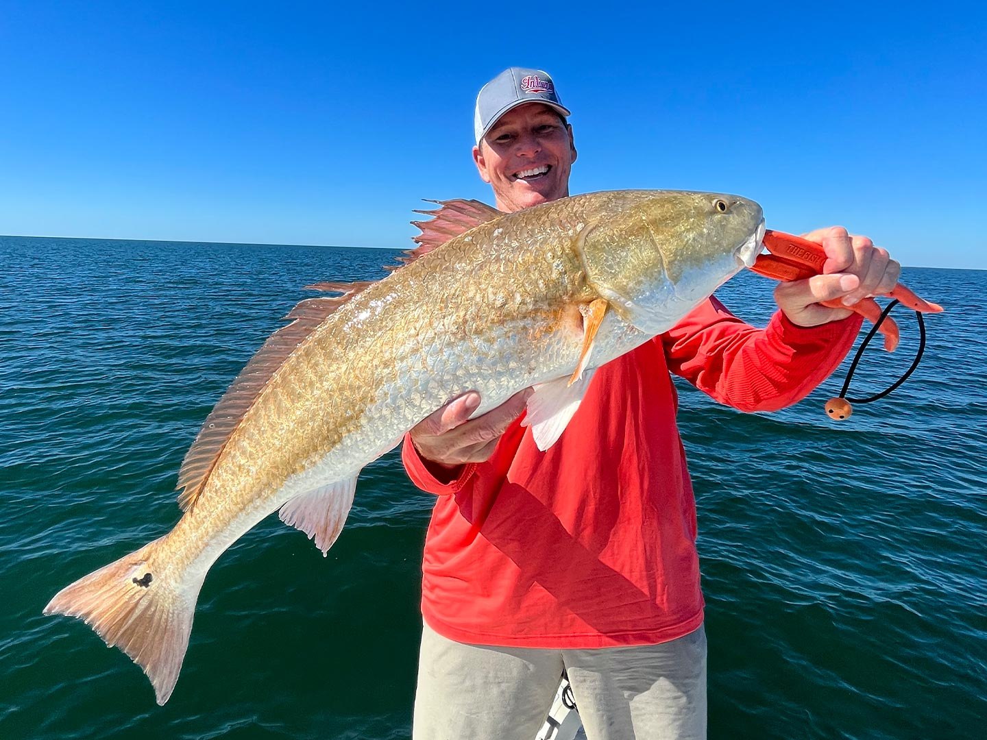 Angler holding a redfish on a Down South fishing trip