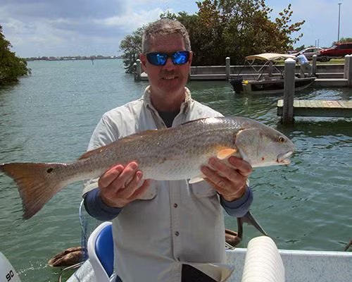 Angler holding a redfish on a Tony Blizzard fishing trip