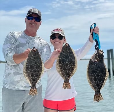Anglers displaying flounder with Captain Chris Driver