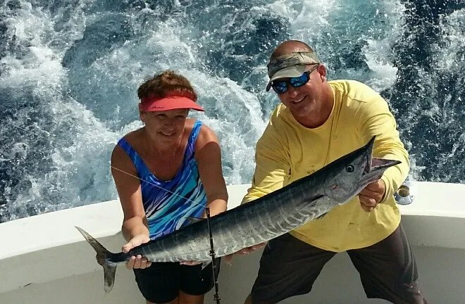 Anglers displaying wahoo with Ultimate Sportfishing