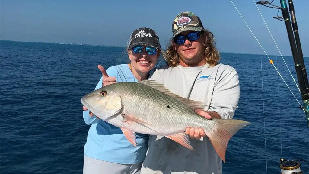 Anglers holding a jack on a Buzz On Islamorada fishing trip