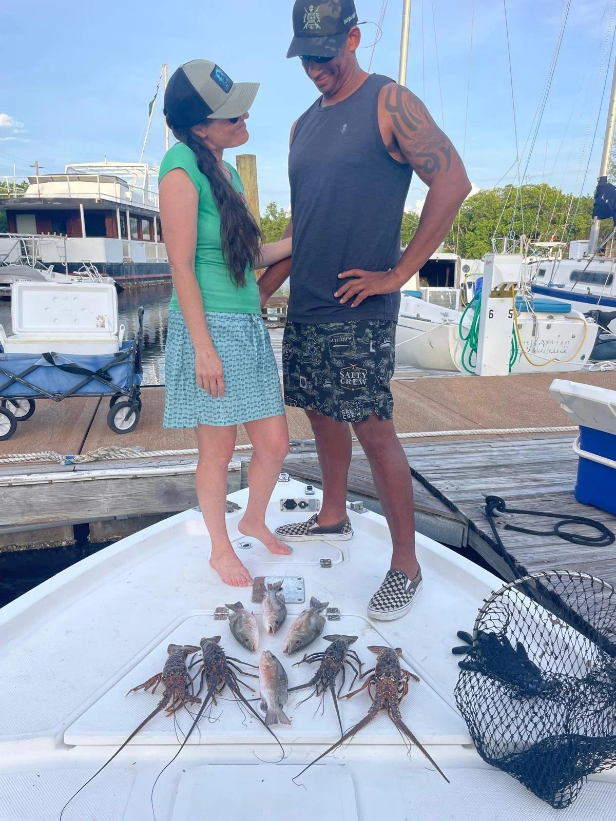 Anglers standing beside a dockside catch on a Pepper Charters trip
