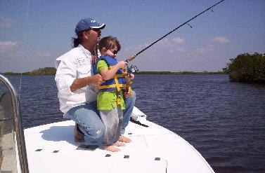 Beach and Backcountry Charters adult helping a child fish