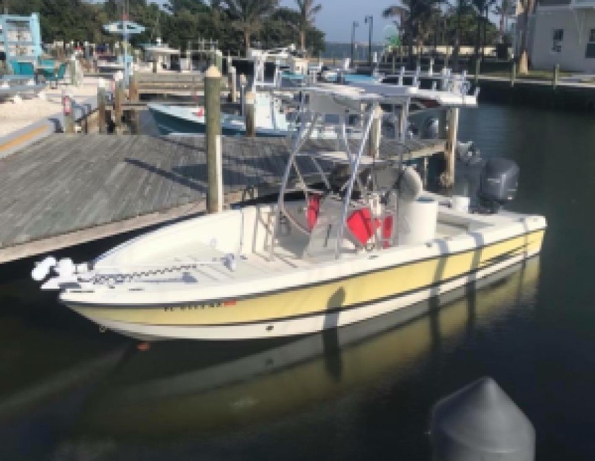 Captain Major yellow and white Hydra Sport bay boat docked