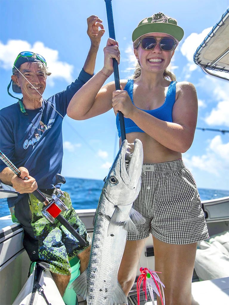 Captain Sunshine angler holding a barracuda