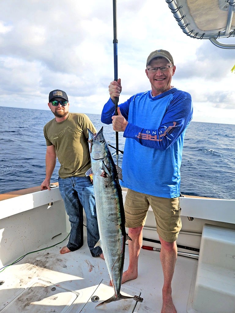 Captain Sunshine angler holding a wahoo