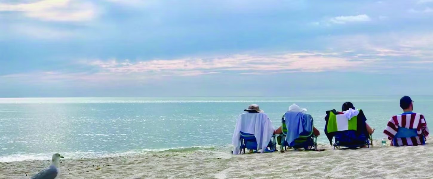 Beach visitors watching the Gulf at Delnor Wiggins Pass State Park