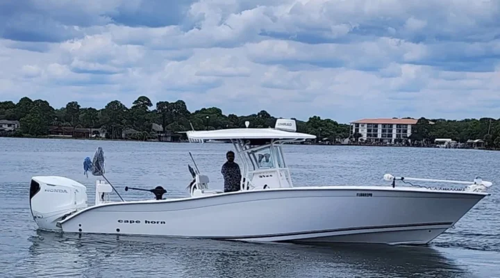 Destin Go Fishing white Cape Horn center console boat with twin Honda outboards on the water