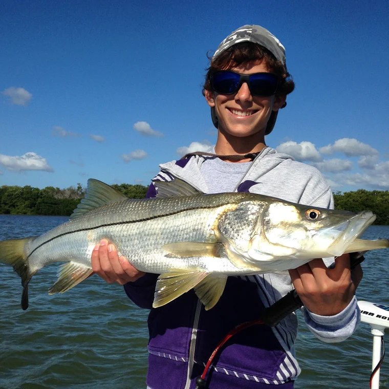 Double Threat angler holding a snook