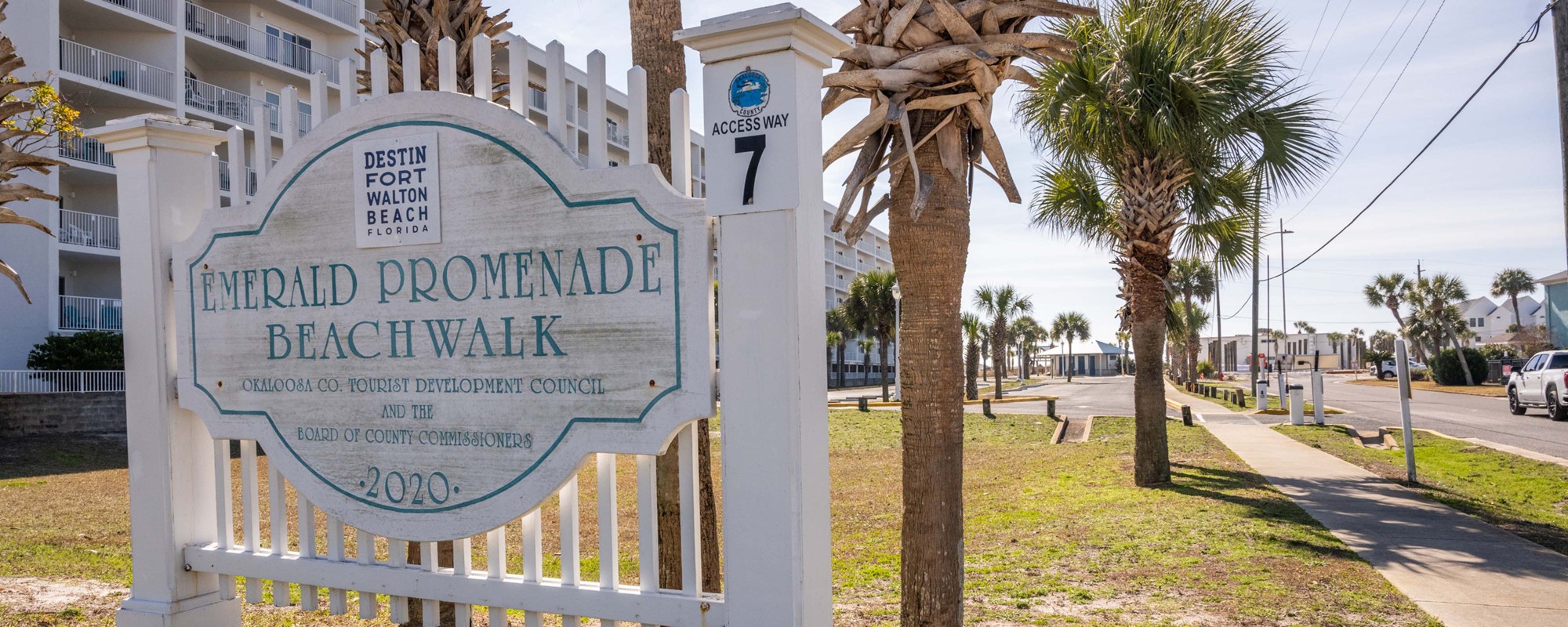 Emerald Promenade Beachwalk sign beside the street entrance