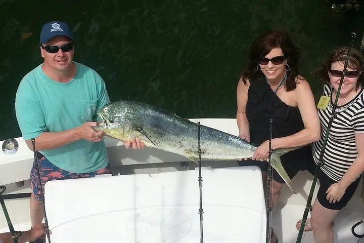 Family holding kingfish on an Ultimate Sportfishing trip