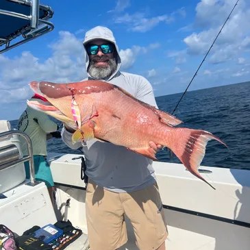 Figured It Out Charters guest displaying a grouper