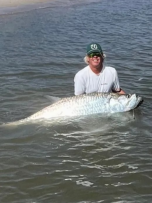 Fish Amelia Island angler holding a tarpon in the water