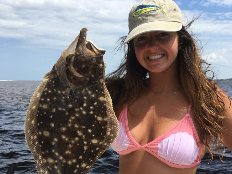 Fish Hunter angler holding a flounder