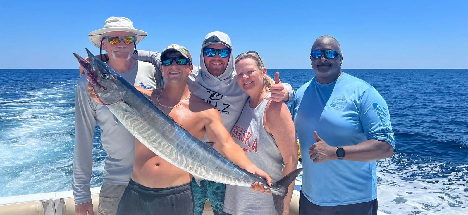 Fishing group displaying a king mackerel on a Testify Charters trip
