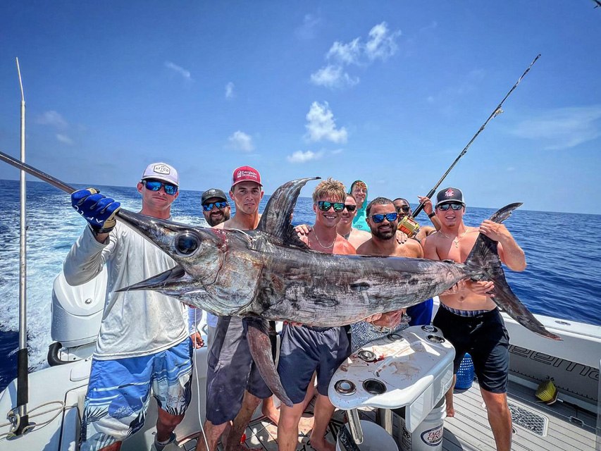 Fishing group displaying a sailfish aboard Vice Versa