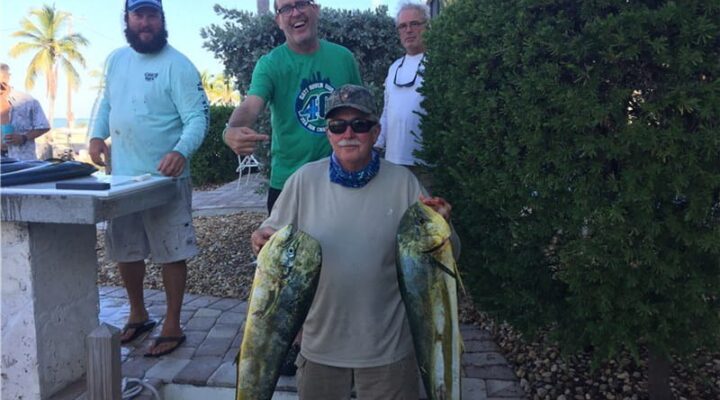Fishing group displaying catches at the dock with Enright Charters