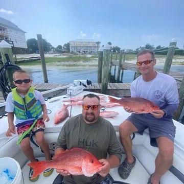 Fishing group with red snapper aboard Twisted Palms Salty Adventures