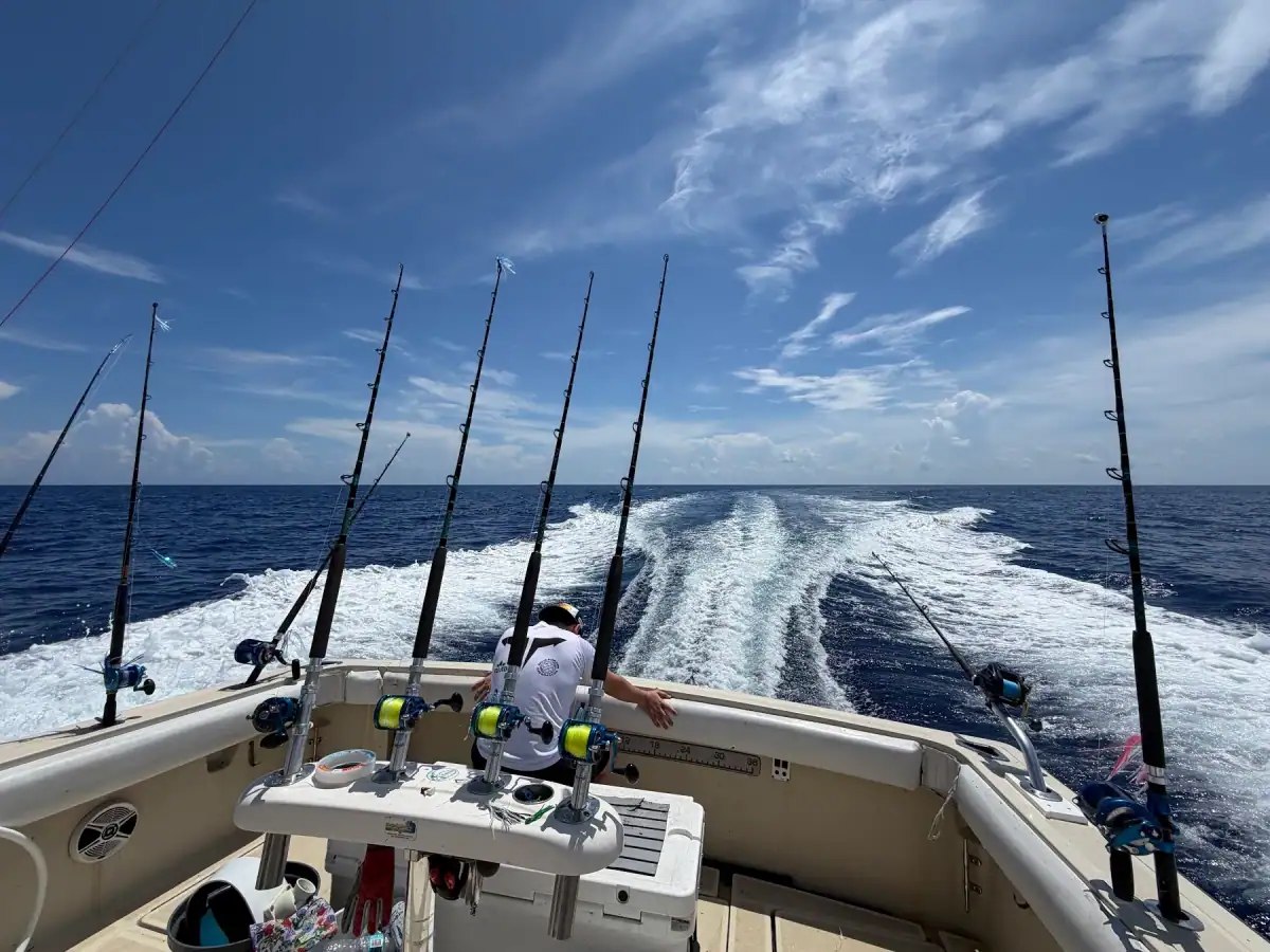 Fishing rods and wake behind the Gradyful charter boat