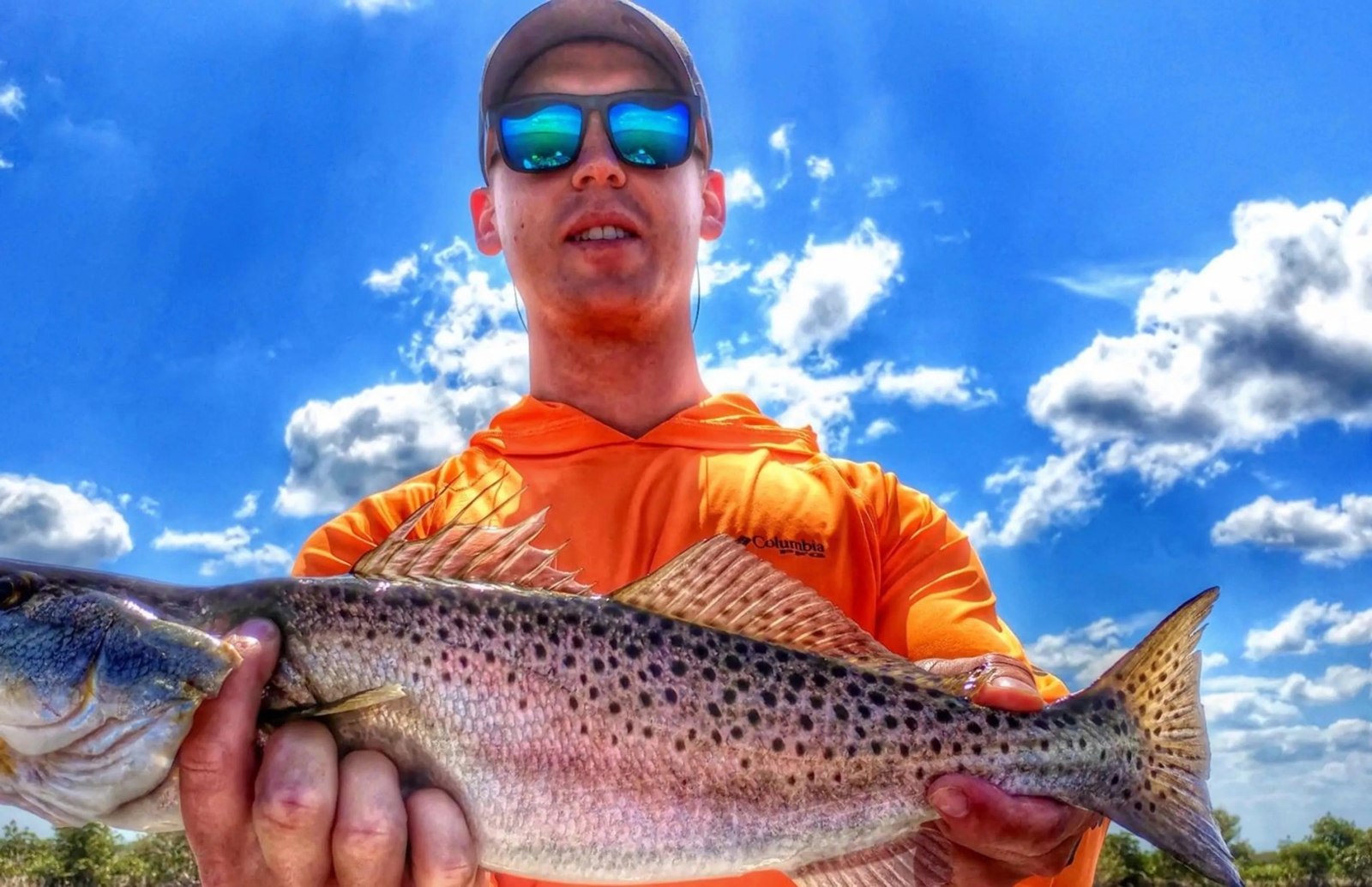 Fishing with Captain Stacy angler displaying a spotted seatrout