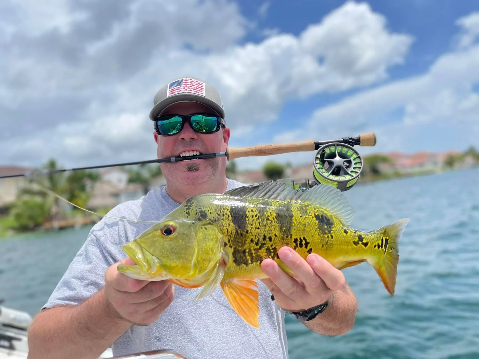 Fly angler holding a peacock bass on a BF Guide Service outing