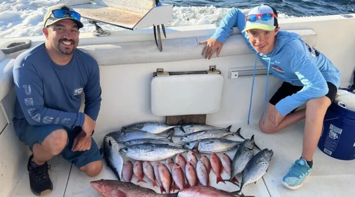 Full Bend Charters guests with a mixed catch displayed aboard the boat