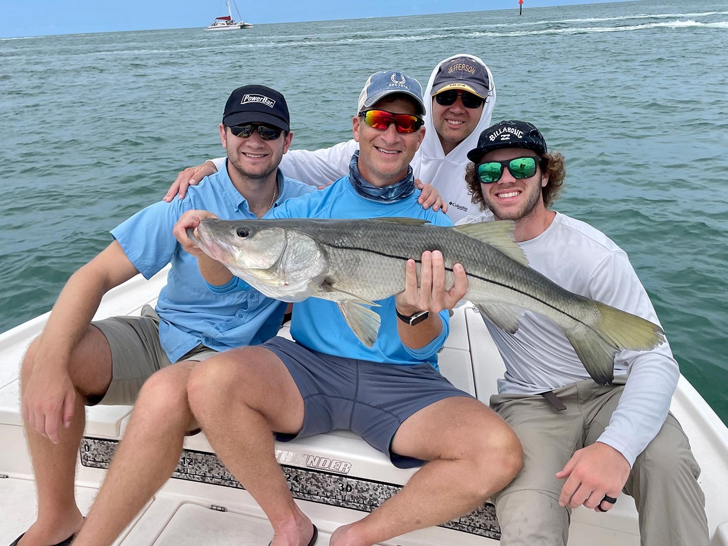 Group displaying a snook with Down South Charters