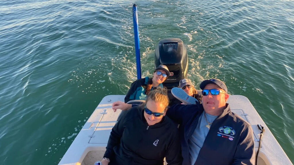 Guests aboard the Lil Buzzy fishing boat on open water